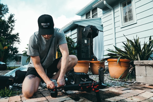 Filmmaker setting up in a home garden landscape